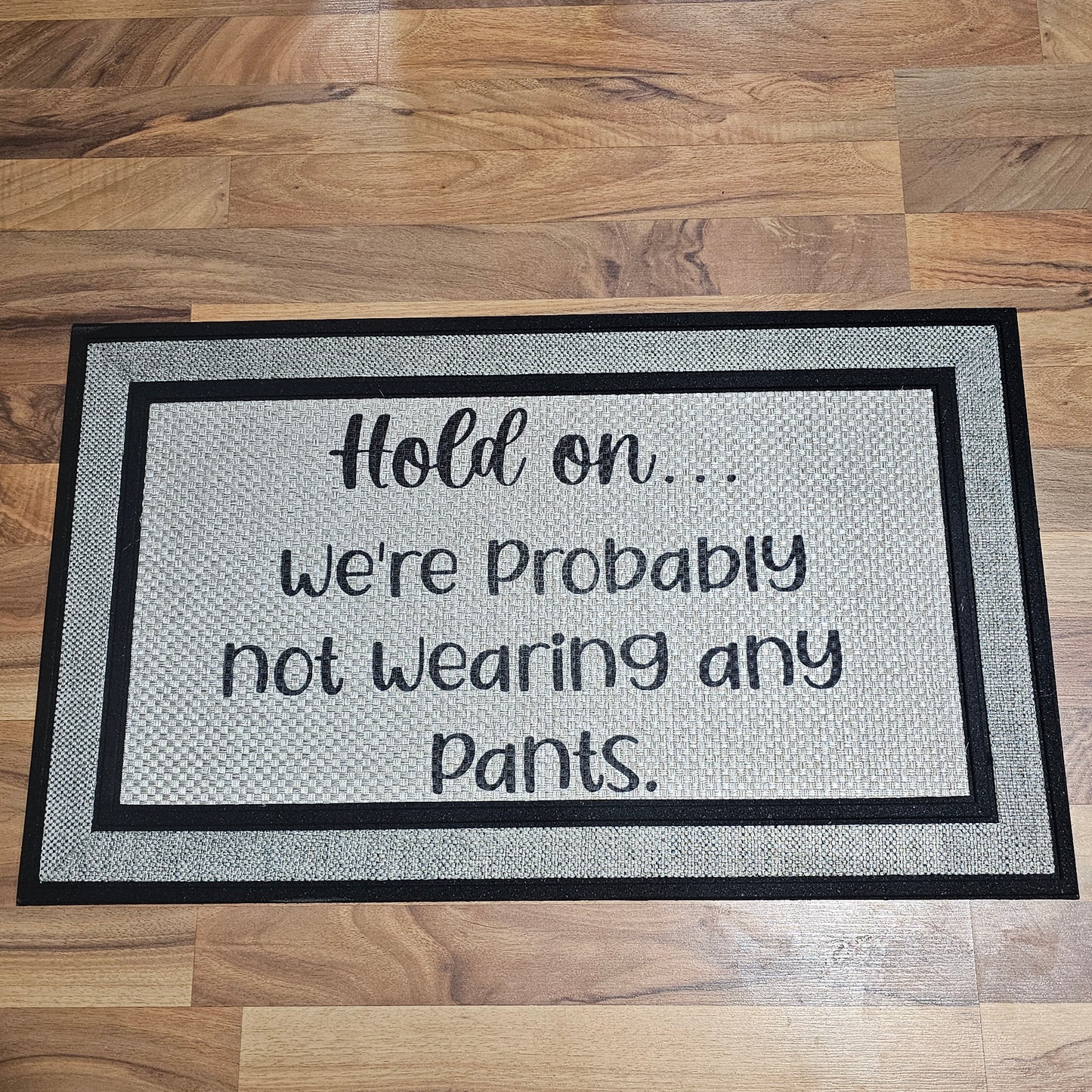 “Hold On, We’re Probably Not Wearing Pants” Welcome Mat